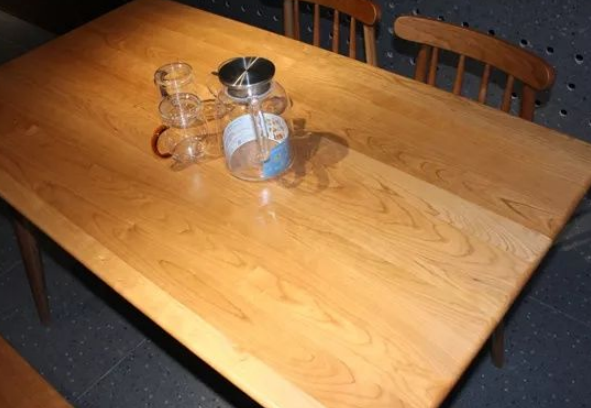 Cherry wood table top with rounded edges.
